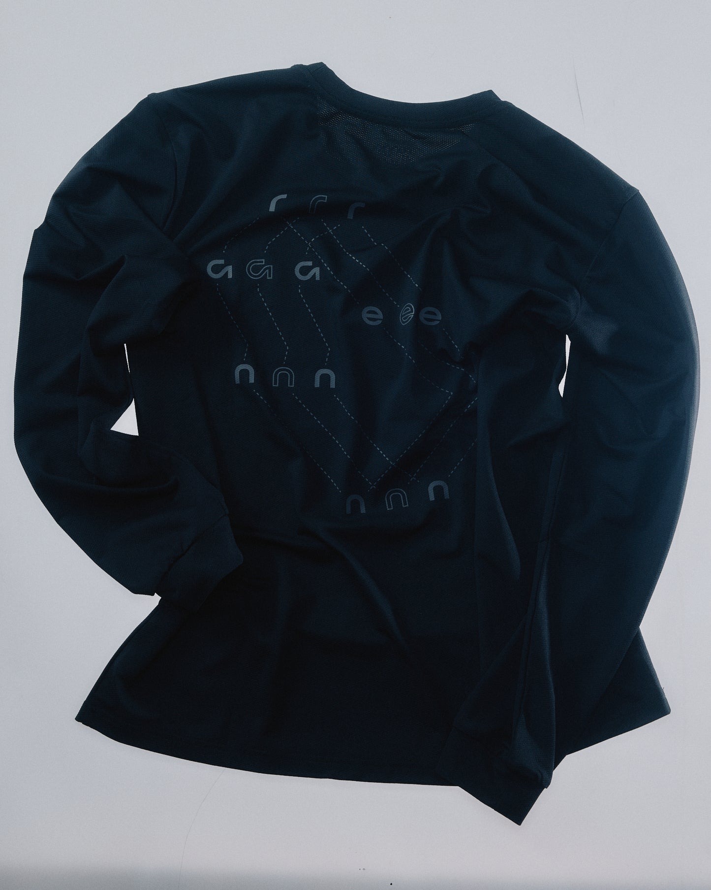 Athlete wearing Renna LS 000001 long sleeve running tee, mid stride